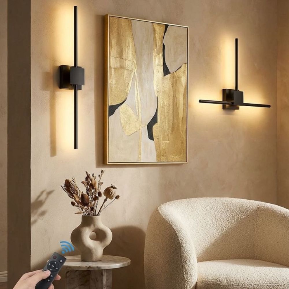 Modern interior design with wall sconces, abstract painting, and a vase.