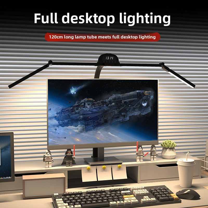 Desk setup with a monitor, keyboard, and lamp highlighting full desktop lighting.