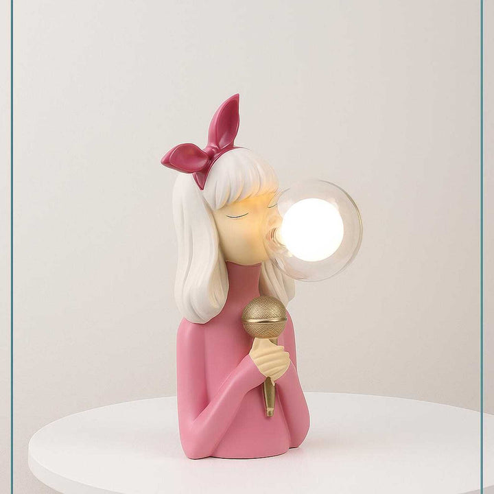 Decorative lamp shaped like a girl with a microphone on a white background