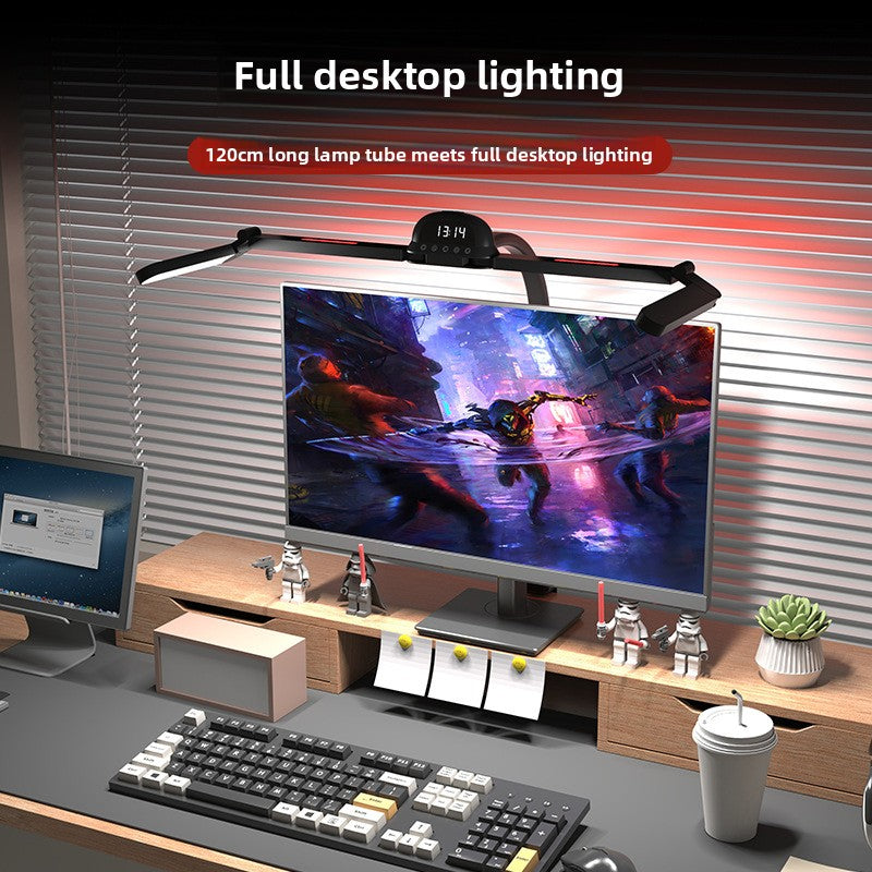 Computer desk setup with a monitor, keyboard, and lamp displaying full desktop lighting.