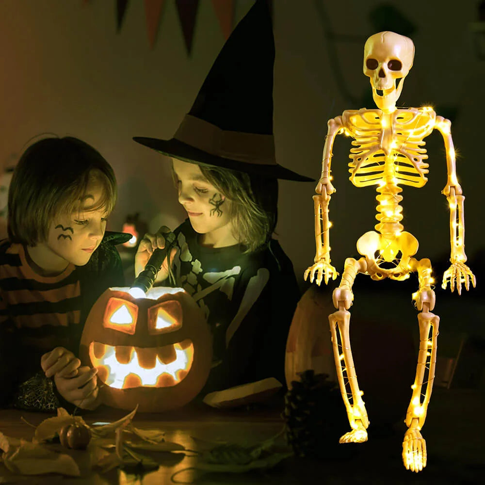 Two children in Halloween costumes with a lit jack-o&